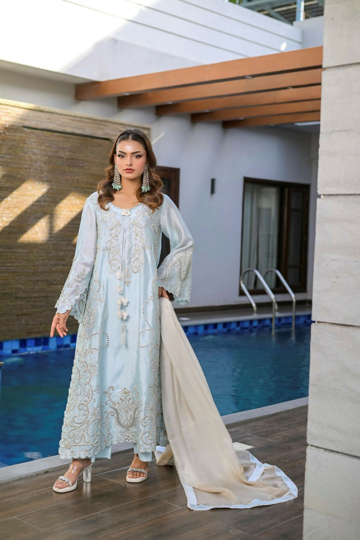 Farooq Hameed Studio 3-Piece FH-703-NAINA in pale blue with intricate silver embroidery and beige dupatta.